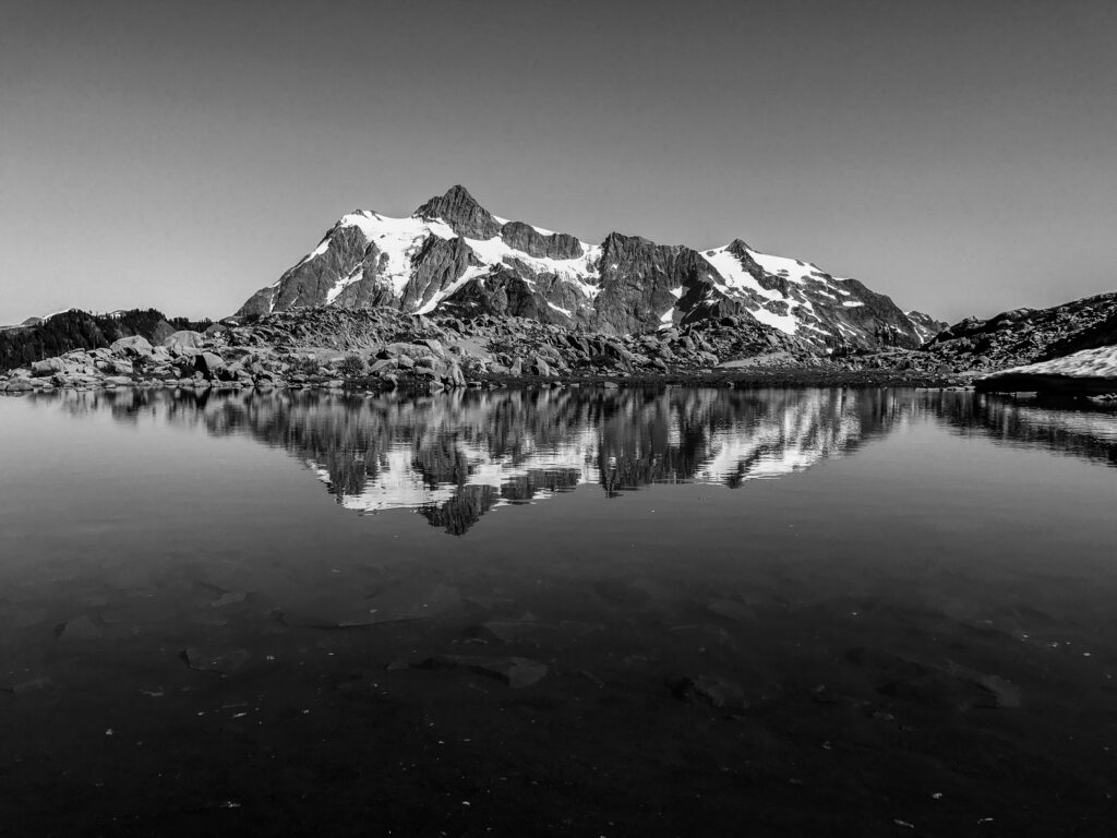 Mount Shuksan reflected on an almost still mountain tarn