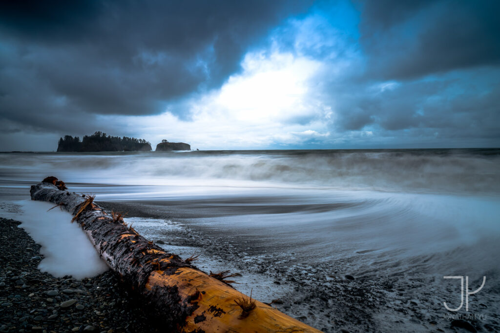 A short break in the storm as the clouds part and light peaks through parting waves as well as the sky