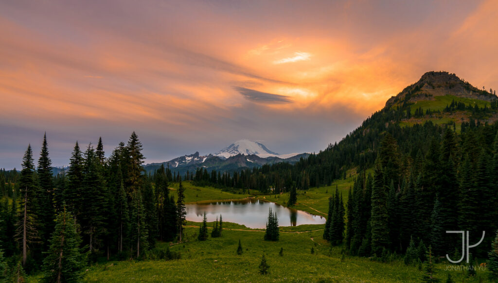 Thick clouds and suffocating smoke do little to block out the burning sunset over Mount Ranier